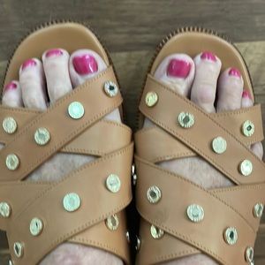 Tan sandals with gold medallions